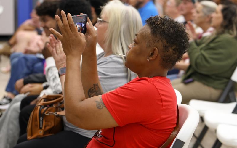 Sheaa Huggs takes photos of her sons receiving recognition at the OCHS winter sports ceremony on March 5, 2026. (Addison Simmons/The Oglethorpe Echo)