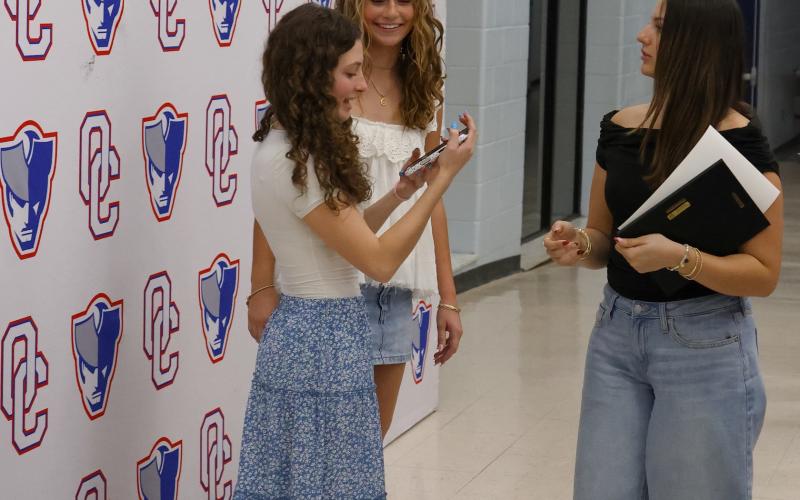 Oglethorpe County High School athletes Emily Wisham and Georgia Turner take photos after the winter sports ceremony at OCHS on March 5, 2026. (Addison Simmons/The Oglethorpe Echo)
