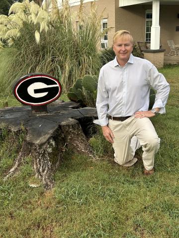 A stump topped with the UGA power "G" symbol sits on the Watson family property in Stephens, created by Ken Watson (pictured) a banker, farmer and UGA alum. His daughter Mary Grace is a freshman at UGA. (Submitted Photo)