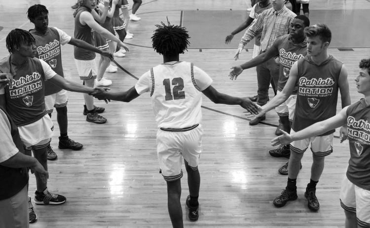 Kirk Ross jogs onto the court as he’s announced prior to Oglethorpe County’s game against Glenn Hills on Tuesday. Ross led the Patriots with 10 points in the 60-48 loss. (Sarah White/The Oglethorpe Echo)