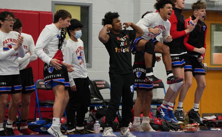 The Oglethorpe County High School wrestling team celebrates after a win against Coosa in a match on Saturday.  (Sarah White/The Oglethorpe Echo)