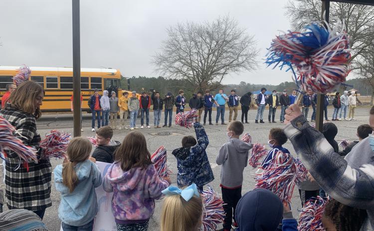 Oglethorpe County Primary School students show off their poster during a sendoff for the OCHS wrestling team. (Meredith Boyd/The Oglethorpe Echo)