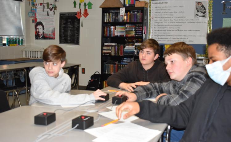 Ashby Booth (from left), James Beach-Colton, Ledger Coley and Kayden Watkins, members of the Oglethorpe County Middle School academic bowl team, practice for the state championship, which is scheduled for Saturday. (Photo/Thomas Ehlers)
