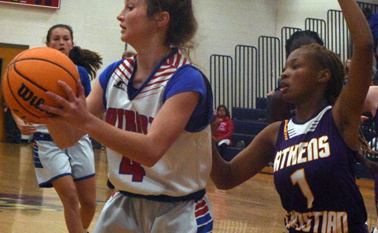 Elin Turner, who is in the eighth grade, keeps the ball away from an Athens Christian School defender in a game on Dec. 2. (Photo/Ralph Maxwell)