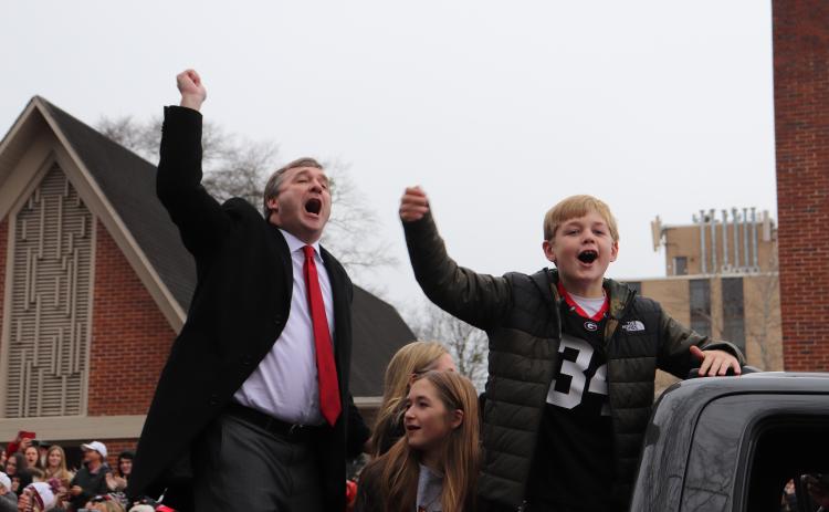 Georgia coach Kirby Smart, son, Andrew, and the Smart family, help fire up the thousands of UGA fans who packed the parade route on Saturday. (Photo/Julianna Russ)