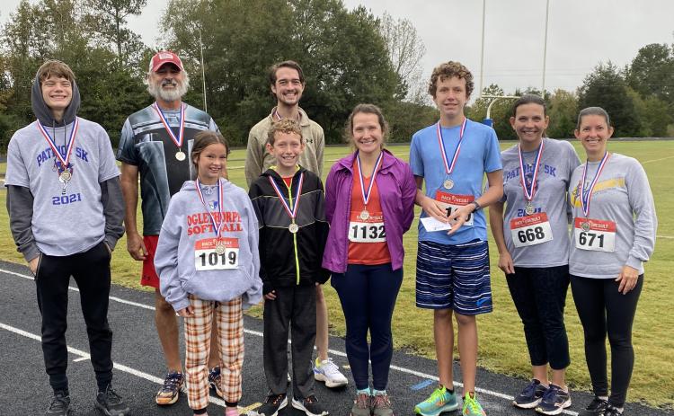 Tanner Mask (back row, from left), Randy Booth, Noah Huff-Merck, (front row, from left) Lannah Scarborough, Micah Dixon, Jennifer Dixon, Noah Dixon, Caroline Paradise Jenny Wisham, were the winners of the Patriot 5k. (Submitted Photo)