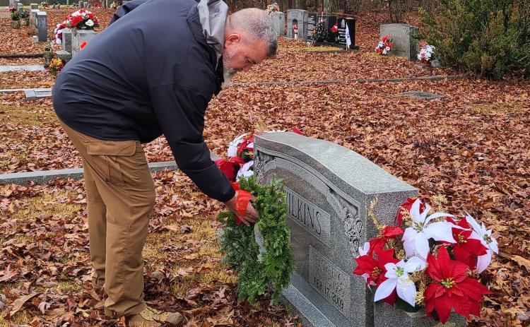 Kevin "Chappy" Hynes places a wreath on the grave of a veteran during the National Wreaths Across America Day at Winterville Cemetery. (Submitted Photo/Sharon Doherty)