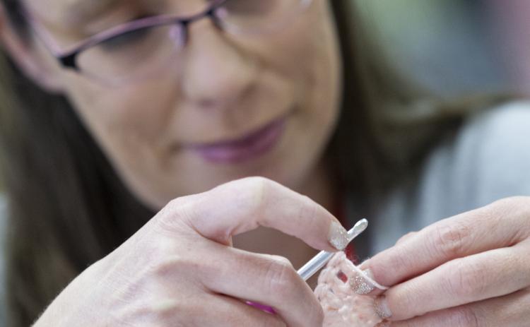 (Sydney Fordice/Oglethorpe Echo) Jennifer Spoor works on a crochet piece during a recent Covered With Love meeting at Lexington Baptist Church. The group of women gathers to crochet afghans to donate to various local groups every year.