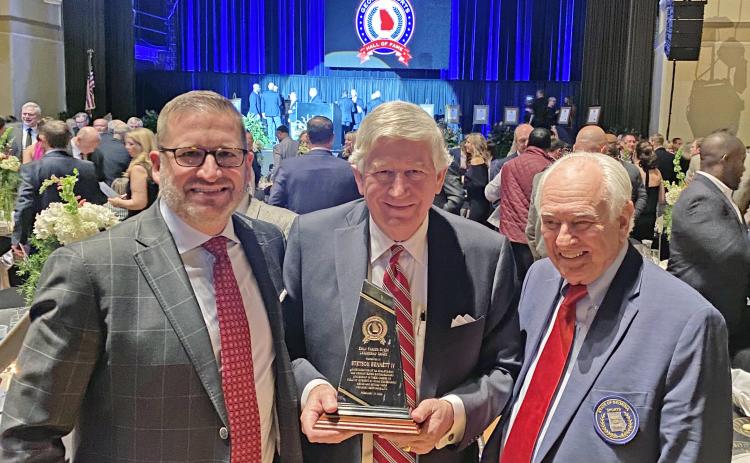 UGA athletic director Josh Brooks (left) and UGA’s Loran Smith flank Dink NeSmith as he displays Stetson Bennett’s leadership award received at the Georgia Sports Hall of Fame banquet on Feb. 19 in Macon. (Jennifer Smith/Submitted Photo)