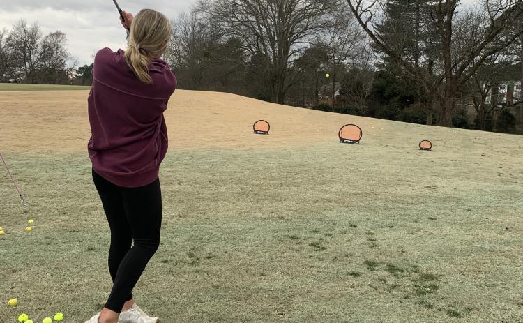 Junior Mackenzie Bowling takes a shot at the University of Georgia golf course. (Meredith Boyd/The Oglethorpe Echo)