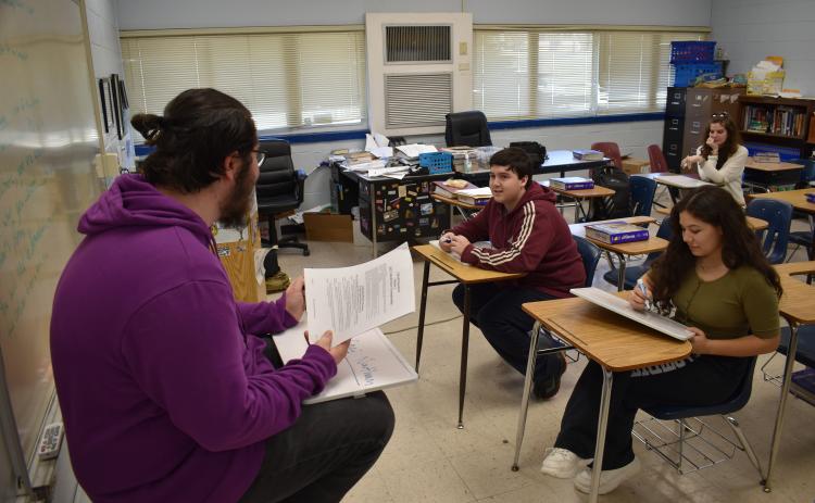 Bo Doker reads a question for Nathan Wilson and Cecilia Negrete. The OCHS academic bowl season just ended, but the team is already preparing for next year. (Thomas Ehlers/The Oglethorpe Echo)
