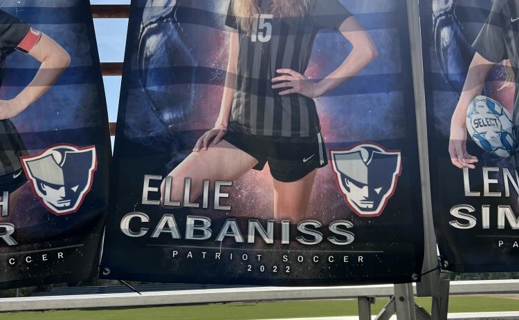 Ellie Cabaniss' senior banner is attached to the back of the bleachers at OCHS stadium. She has been home schooled, but is taking one class at OCHS while also dual enrolled at UGA. Submitted photo