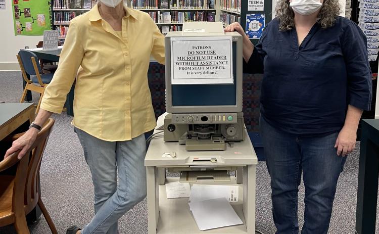 Jean Westmacott and Amanda Chapman stand next to the old microfilm reader in the  Oglethorpe County Library that needs to be replaced because it no longer works. (Submitted Photo)