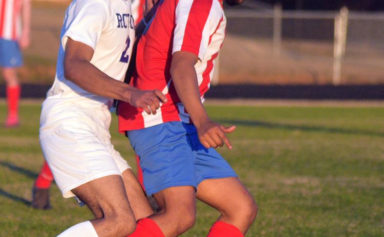 Erick Lopez-Salazar keeps the ball away from a Richmond County Technical Career Magnet School player in the Patriots' 9-0 win on Feb. 25. (Ralph Maxwell/ Submitted Photo)