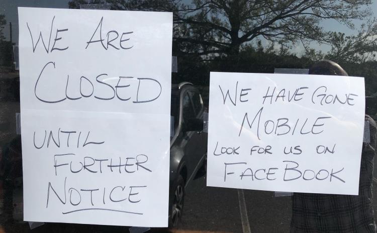 Signs on the door of Trava’s Dog Gone Good Cafe states that it’s closed. (Photo/Andy Johnston)