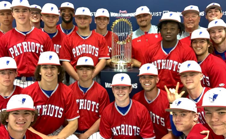 The Oglethorpe County baseball team had its photo taken with the 2021 World Series Trophy at a doubleheader at Elbert County last week. The Atlanta Braves won last year’s World Series. (SUBMITTED PHOTO)