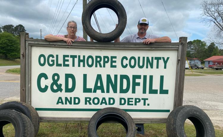 In celebration of Earth Day, the Oglethorpe County  Landfill is hosting an opportunity for local residents  to dispose of unwanted passenger-vehicle tires.  Scale  house operator Heidi Tidwell, left, and public works di- rector Adam Nation, right, pose to promote this Friday  (8 a.m. to 4:30 p.m.) and Saturday’s (8-11:30 a.m.) event  at 882 Athens Road in Crawford. (Dink Nesmith/The Oglethorpe Echo)