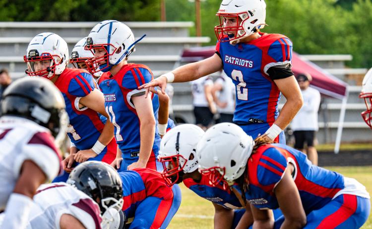 OCHS Jake Turner readies the line as the special teams unit prepares for a punt. The Patriot varsity team played three quarters before the junior varsity players substituted. (Photo/Jack Casey)