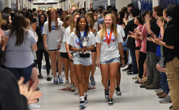 Jayda Jones (left) and Maddie Williams lead the girls track team through Oglethorpe County Middle School during the first stop on their state championship parade on May 17. The team stopped at all three feeder schools and the central office before a celebratory lunch. (Photo/Thomas Ehlers)