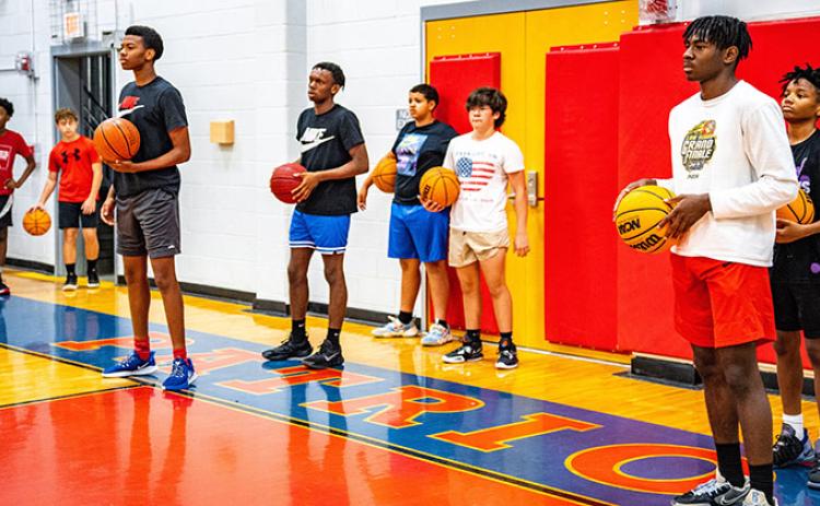 Campers line up to participate in drills at the Larry Brown Basketball Camp at the OCHS gym last week. The campers worked on their basketball skills from 9 a.m.-1 p.m. daily. (Photo/Jack Casey)