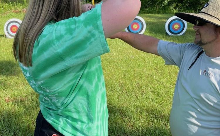 Oglethorpe County High School’s Keaton Gaines listens to an instructor during an archery class at the Natural Resources Conservation Workshop last month. (Submitted Photo)