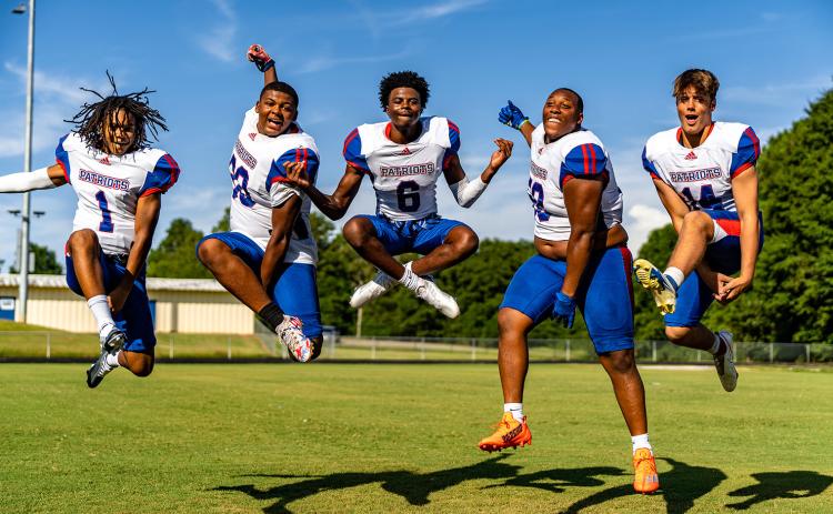 Oglethorpe County football players Jordan Johnson (1), Jayland Richardson (30), Darius Heard (6), K.B. Bonds (58) and Ashton Sexton (14) appear to be jumping for joy for the start of the 2022 high school football season. The Patriots open at home against East Jackson at 7:30 p.m. Friday. (Photo/Jack Casey)