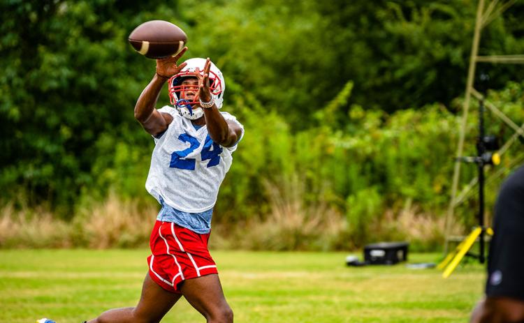 Tristan Anderson snags a pass during football practice this week as the Patriots prepare for their first game on Aug. 19. (Photo/Jack Casey)