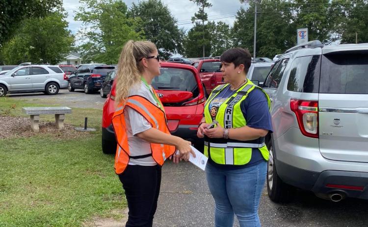Oglethorpe County Sheriff’s Office Sgt. Samantha Mathe, right, was part of a group that checked child booster seats at the primary school. (Submitted Photo)