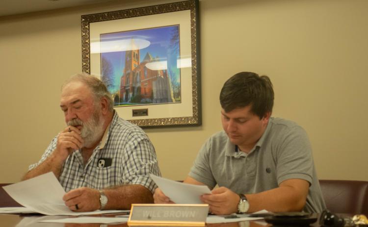 (KATIE TUCKER/THE OGLETHORPE ECHO) Commissioners Phil Sanders, left, and Will Brown, look over notes at the monthly commission meeting on Monday night.