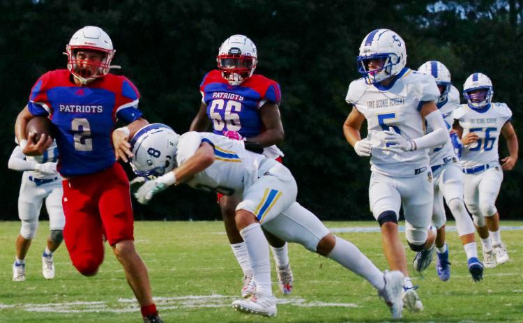 Oglethorpe County’s Jake Turner brushes off Lake Oconee Academy’s Cameron Kelley on his way to rushing for 113 yards on only 13 carries in the Patriots’ 42-0 victory earlier this month. (Alyssa Ginn/The Oglethorpe Echo)