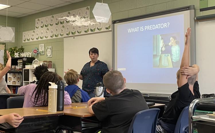 (KENNEDY LEWIS/ THE OGLETHORPE ECHO) Fifth-grade students at Oglethorpe County Elementary School listen to Sgt. Samantha Mathe talk about internet safety as a part of the C.H.A.M.P.S. program.