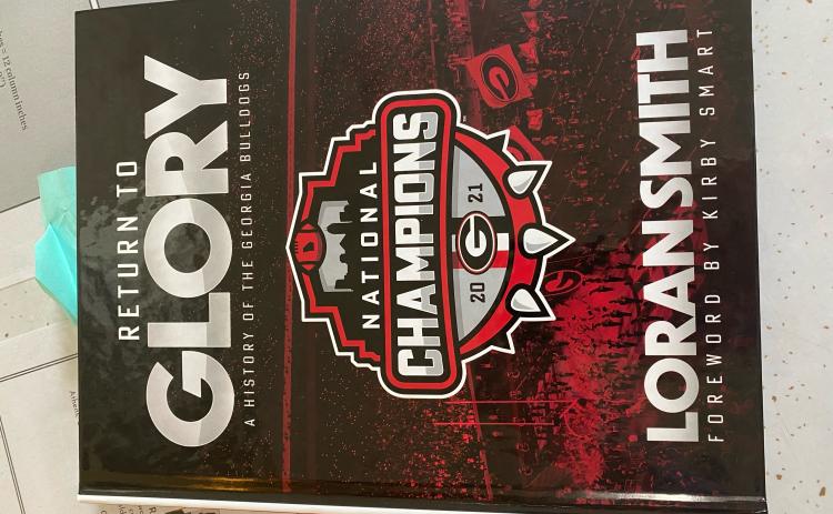 (Dink NeSmith/The Oglethorpe Echo) Loran Smith’s latest book, titled “Return to GLORY: A History of the Georgia Bulldogs,” includes the 2021 national title season.