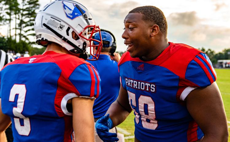 Quarterback Will Sampson, left, and lineman K.B. Bonds get fired up before Oglethorpe County’s season-opening 16-7 victory over East Jackson. The Patriots are 1-0 for the first time since 2011. (Jack Casey/ The Oglethorpe Echo)