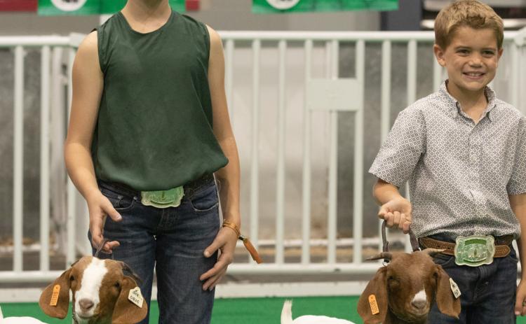 Naomi (left) and Cam McPeake pose with their award winning animals on Saturday, Oct. 8, 2022 at the Georgia National Fair in Perry, Georgia. (Photo/Katie Tucker)