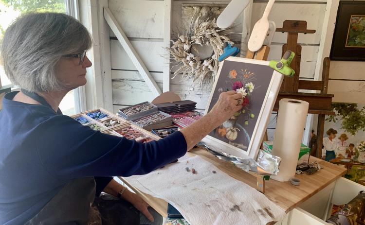 Artist Mary Ann Cox, who works on a new pastel still-life at her studio during the Art Crawl, took advantage of the event to meet new folks.
