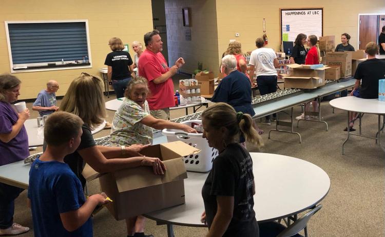 Volunteers at Lexington Baptist Church sort food into boxes for families visiting the mobile food pantry. The boxes of food are dispersed drive-through style every second Monday of the month. (Submitted Photo)