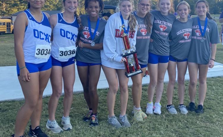 Lesley Ramirez (from left), Elin Turner, Sydnie Henderson, Lizzie  Wadsworth, Hannah Hemingway, Mylee Nimmons, Sarah Taft  and Harper Palmer led the Oglethorpe County girls cross country team to a win at the Kent Kramer Cross Country Classic. (Submitted Photo)