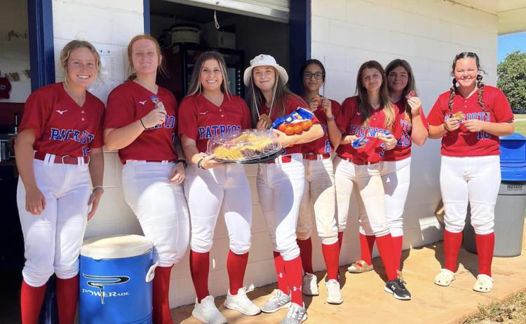 The Oglethorpe County softball team enjoys a snack to help refuel for a game. Oglethorpe County Family Connection’s “Nutrition Hydration” helps take some of the burden of feeding athletes off their parents. (Submitted Photo)
