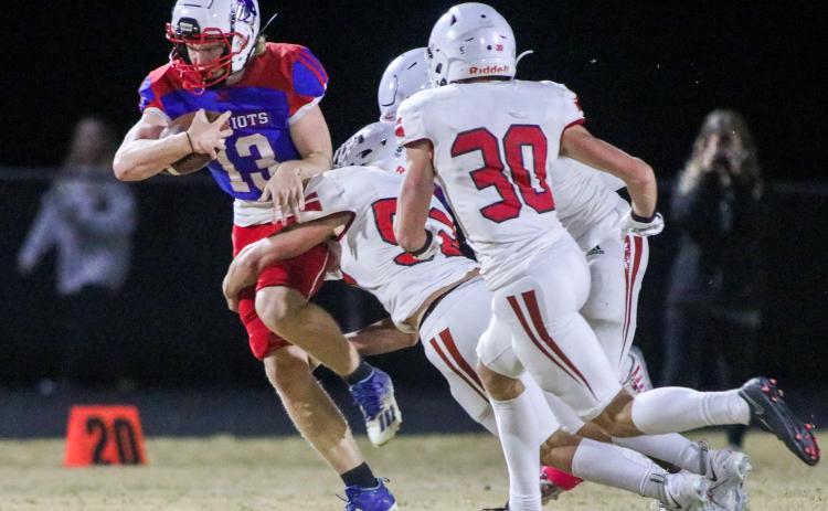 OCHS strong safety Nate Irwin attempts to break free from Social Circle defenders Grayson Jenkins and Bryan Ross. OCHS homecoming game, Friday, Oct. 28, 2022. (Aisha Schulz/The Oglethorpe Echo)
