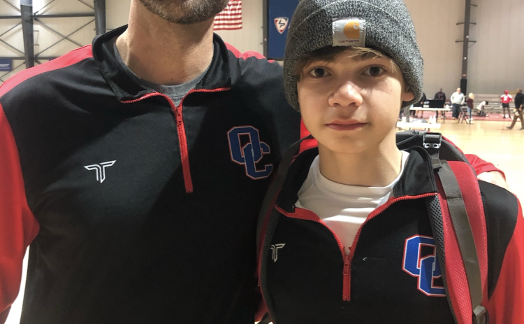 OCHS wrestler Miles Mason (right) said he works well with his father Steve (left) and learns from his dad’s coaching. (Submitted Photo)