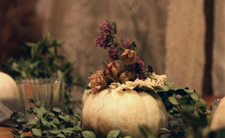 Floral artist Jenny Derevere adds both homegrown and foraged dried Nigella, Monarda, snapdragon and Scabiosa, or pincushion flower, to a white pumpkin for a twist on natural fall decor. She uses blossom from her flower farm in Stephens. (Photo/Isabelle Manders)