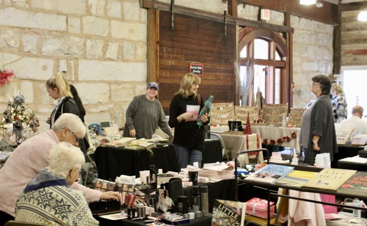 A variety of vendors filled the Crawford Depot during the annual Christmas Mar- ketplace last weekend. Items ranged from hand-poured candles to used books, woven quilts and original photography and paintings. (Lily Baldwin/The Oglethorpe Echo)
