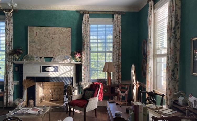 Boldly patterned, floor to ceiling curtains in one of Linda Parish’s front rooms serve as a focal point. (Photo/Erin Kenney)