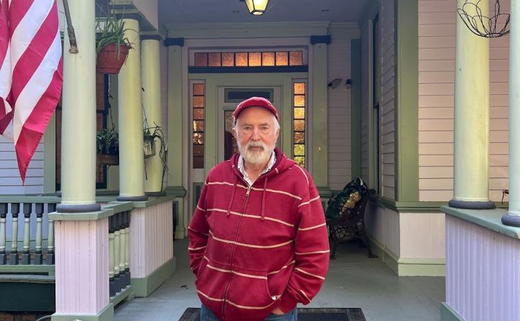 Tom Sheridan stands in front of the Crawford home he shares with his wife Sandra. They referred to a book called “Barber’s Turn-of-the-Century Houses” to help them restore the home like it might have looked more than 100 years ago. (PEYTON JENKINS/THE OGLETHORPE ECHO)