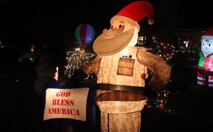An inflatable Santa in U.S. military camouflage is part of the Christmas display in Wayne Loggans’ yard on North Street in Crawford. Loggans and his wife Tammy decorate their yard every year. (LJ Jackson/The Oglethorpe Echo)