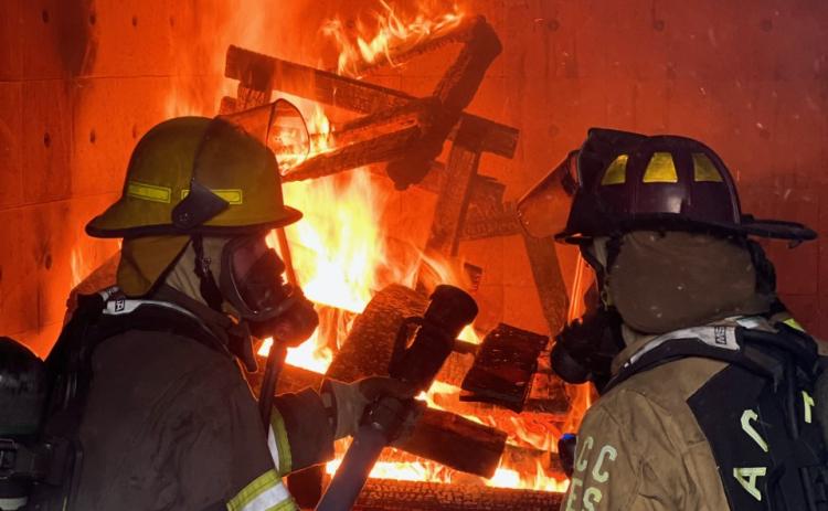 Volunteer firefighters-in-training take part in a live burn test on Saturday, Dec. 3. The live burn test, where firefighters must put out a fire in a controlled environment, is a requirement to become certified. (Photo/submitted)