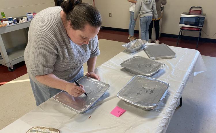 Amber Waldroup, who started at the UGA Extension Office last September, labels dishes at a recent Cooking to Share Program. (ERIN KENNEY/THE OGLETHORPE ECHO)