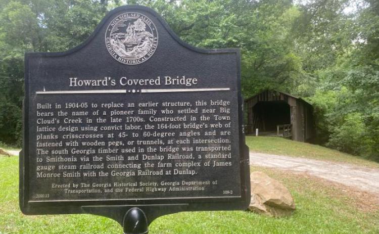 The historical marker tells the story of Howard’s Covered Bridge, which has been covered with graffiti. (Dink NeSmith/The Oglethorpe Echo)