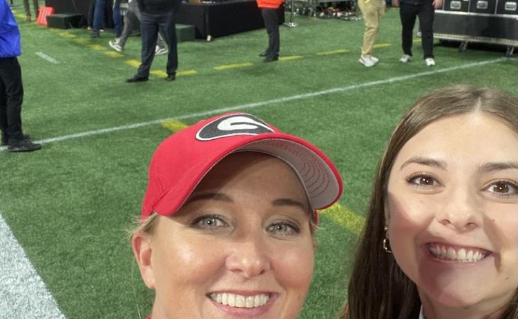 Katy Wilkins (left) and Braelynn Neely snap a selfie in front of the College Game Day set at the Peach Bowl. Neely and Wilkins work for the Redcoat Band Auxiliary Unit. (Submitted Photo)