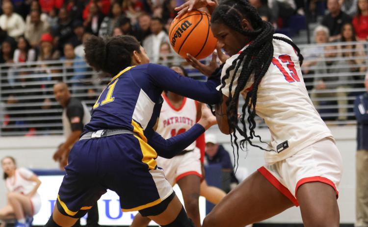 Kenzie Henderson, a sophomore, plays keep-away from her opponent in a basketball game between Oglethorpe County High School and Prince Avenue Christian School on Feb.3, 2023. The Patriots defeated the Wolverines 58-57 in the region matchup. (Photo/Emily Dozier)